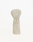 Beige golf club head cover with green stripe on a white background