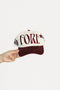 Cap with 'FORE' text held by a hand on a white background