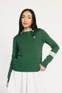 Woman wearing a green Dorothy sweater with a white collar against a white background