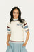 Woman wearing a striped sweater, light blue skirt, and white sneakers on a white background