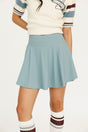 Smoke blue Manhattan skirt worn by a person on a white background