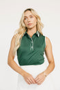 Woman wearing a green sleeveless Moore Polo shirt with white trim on a plain background