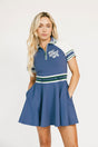 Woman wearing a blue and white dress with a logo on a white background