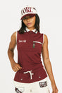 Woman wearing a maroon sleeveless polo shirt and cap with white accents, standing against a plain background.