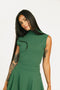 Woman wearing a green dress Manhattan Mock Neck against a white background