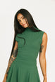 Woman wearing a green dress Manhattan Mock Neck against a white background