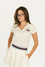 Woman wearing an angora Brooklyn Polo featuring a 'Fore All' logo on the left chest.