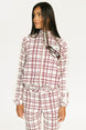Woman wearing a merlot and white plaid Lyla Jacket on a plain background
