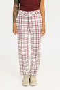 Person wearing red plaid Fore All Sloan Pants on a white background. Featuring a double snap closure and side seam pockets.