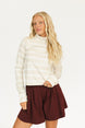 Woman wearing an angora and white Lottie Mock Neck with the Eleanor short in merlot.