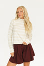 Woman wearing an angora and white Lottie Mock Neck with the Eleanor short in merlot.