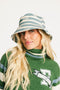 Person wearing the Fore All Austi Bucket Hat with a green sweater with a logo