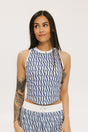 A woman wearing a blue geometric patterned tank top with a built-in bra, paired with matching pants.