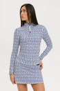 A woman wearing a mock neck, long sleeve Bea Base Mock top in an indigo and white pattern.