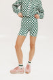 A person wearing green and white checkered biddy shorties and a matching checkered golf jacket, standing against a white background.