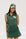 A female model wearing a sleeveless green pinstripe polo top with an applique logo on the chest and a matching green skirt, paired with a green cap.