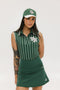A female model wearing a sleeveless green pinstripe polo top with an applique logo on the chest and a matching green skirt, paired with a green cap.