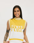 A sleeveless mock-neck sweater with intarsia knit design, featuring horizontal yellow and white stripes and the word 'FORE' printed across the chest.