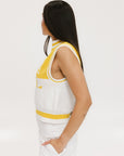 A sleeveless mock-neck sweater with intarsia knit design, featuring horizontal yellow and white stripes and the word 'FORE' printed across the chest.