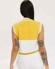 A sleeveless mock-neck sweater with intarsia knit design, featuring horizontal yellow and white stripes and the word 'FORE' printed across the chest.