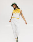A sleeveless mock-neck sweater with intarsia knit design, featuring horizontal yellow and white stripes and the word 'FORE' printed across the chest.