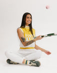 A sleeveless mock-neck sweater with intarsia knit design, featuring horizontal yellow and white stripes and the word 'FORE' printed across the chest.