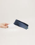 A hand holding a visor with 'FORE' written in bold letters on the front and '04' on the back, against a white background.