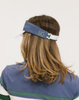A model wearing a visor with 'FORE' written in bold letters on the front and '04' on the back, against a white background.