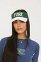 A model wearing a green and white visor with the text 'FORE' across the front.