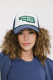 A model wearing an indigo and white hat with the text 'DOUBLE BOGEYS ARE HOT' on the front