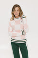 A woman wearing a pink and white checkered intarsia knit sleeveless sweater with a rounded neck.