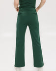 A pair of green Simone Pant with white stripes on the side, front and back pockets, and a zipper fly with snap closure.