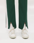 A pair of green Simone Pant with white stripes on the side, front and back pockets, and a zipper fly with snap closure.