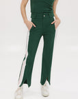 A pair of green Simone Pant with white stripes on the side, front and back pockets, and a zipper fly with snap closure.