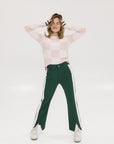 A pair of green Simone Pant with white stripes on the side, front and back pockets, and a zipper fly with snap closure.