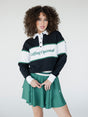 A person wearing a long sleeve polo shirt with horizontal green and white stripes and the text 'Golfing Optional' on the chest, paired with a green skirt.