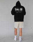 "Close-up of the 'Global Hoodie' from the Royal Collection, inspired by autumn hues. This cozy, slightly oversized hoodie features a substantial pocket for golf and personal items and a full-coverage hood. 'Fore All' details on the front and back include the classic 'Golfing Optional' phrase in five languages. Perfect for combining comfort and global style this season."
