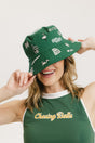 A person wearing a green bucket hat with white embroidered icons.