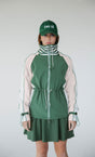 A person wearing a green Elle Rain Jacket with a matching green hat, standing against a white background.