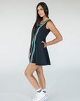A model wearing a black sleeveless dress with a green vertical stripe detail on the front, designed with a flattering silhouette.